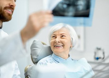 Invisalign aligner being placed on mold of teeth