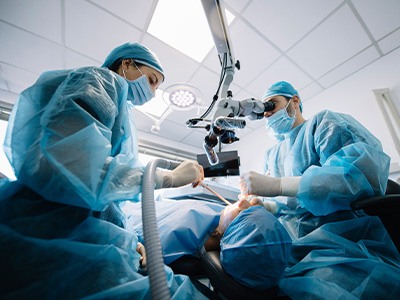 Dentists performing a dental implant surgery