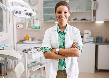 Dentist with black glove holding clear aligner