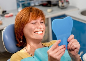 Woman smiling while sitting in treatment chair