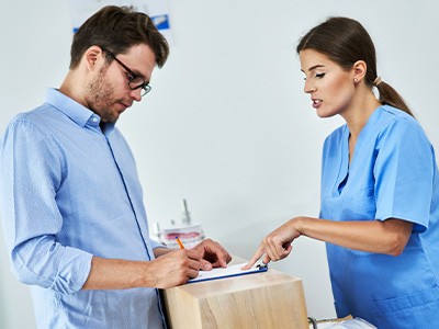 A man paying for his dental care