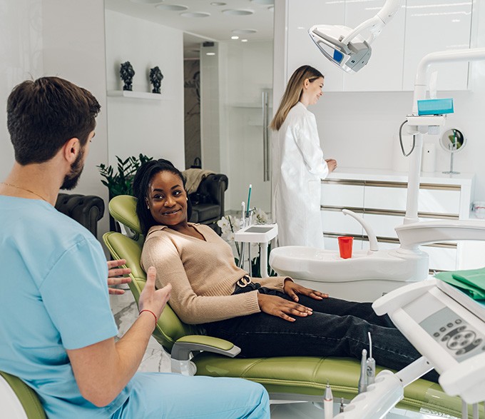 a dentist speaking to a patient 